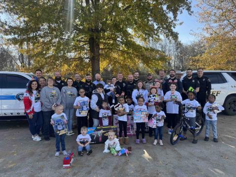 Most of the children participating in this year’s Shop with a Cop event are shown with their favorite toy and all of the law enforcement and Walmart personnel who helped make this very special day possible. Photo courtesy of HPD.