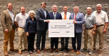 Wearing big smiles for the big grant award and the big $12.5 million check are, from left, Britton Lightsey, Dr. Alex Smith, Joyce Fowler, Garlan Gudger, Dr. Joel Hagood, Josh Weatherly, Dr. Patrick Sutton, Daryl Weatherly and Mark Dearen.