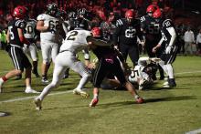 Jaquan Reeder takes the ball across the goal line.